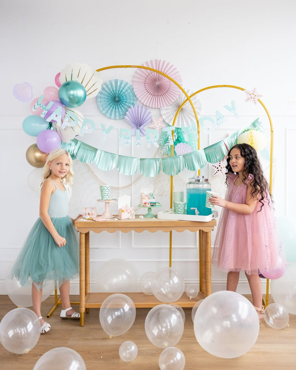 Pastel mermaid birthday decorations with balloons and two girls from Parte Haus party supply store in Bethesda MD