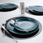 Blue and black dinnerware set with clear cutlery and monogram napkin table setting from Parte Haus party supply store in Bethesda Maryland