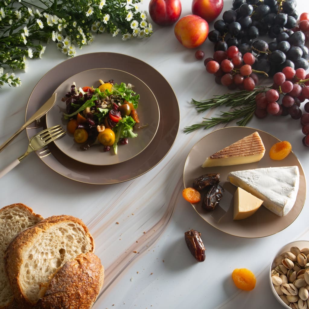 Taupe dinnerware with gold utensils salad and cheese on elegant table summer gathering from Parte Haus party supply store in Bethesda Maryland