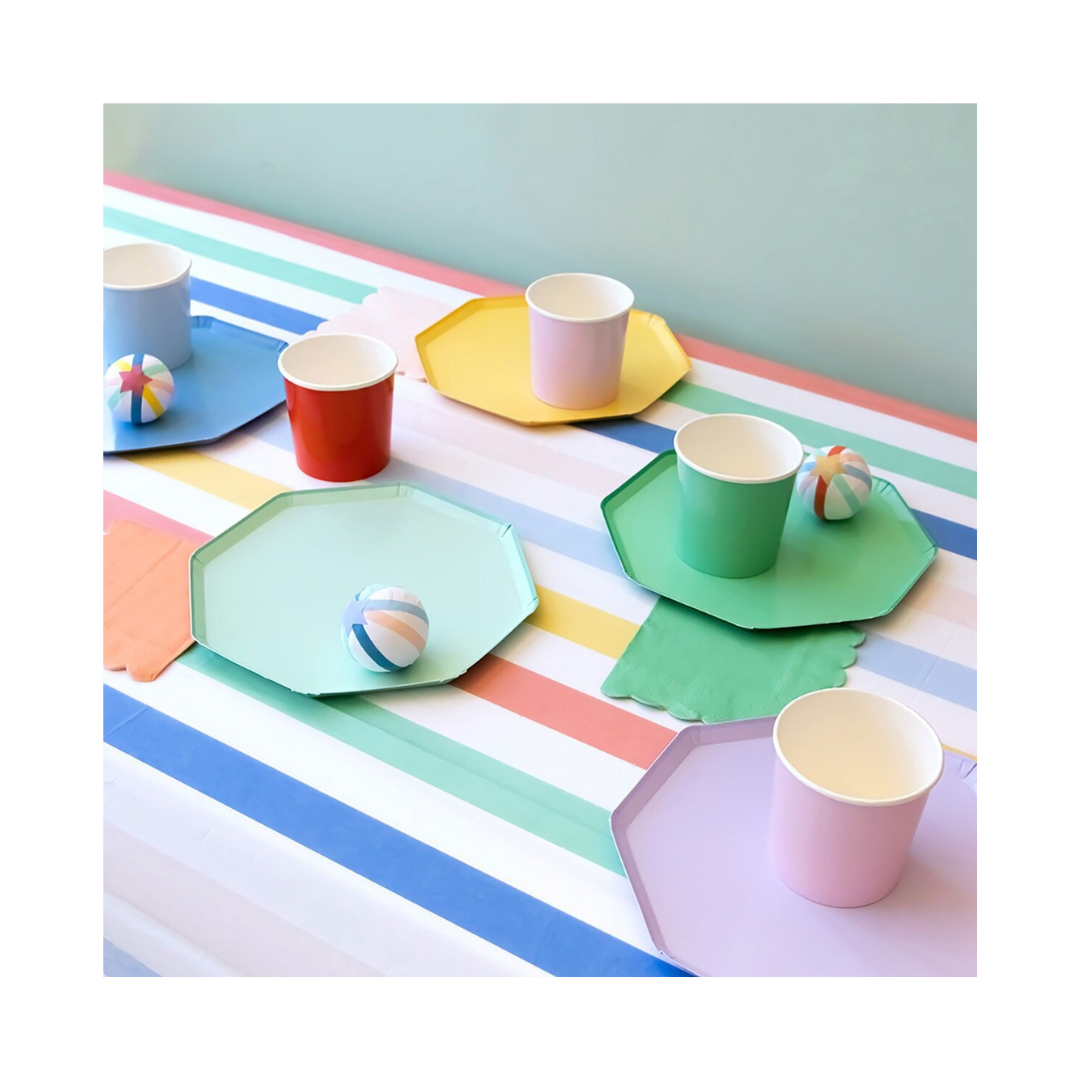 Pastel rainbow plates and cups with striped tablecloth kids birthday decor from Parte Haus party supply store in Bethesda MD