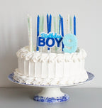 Blue and white birthday cake candles on a white frosted cake for boy birthday from Parte Haus party supply store in Bethesda MD.