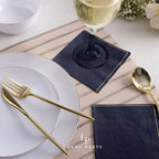 Navy blue napkins gold cutlery white plates elegant table decor for dinner from Parte Haus party supply store in Bethesda Maryland