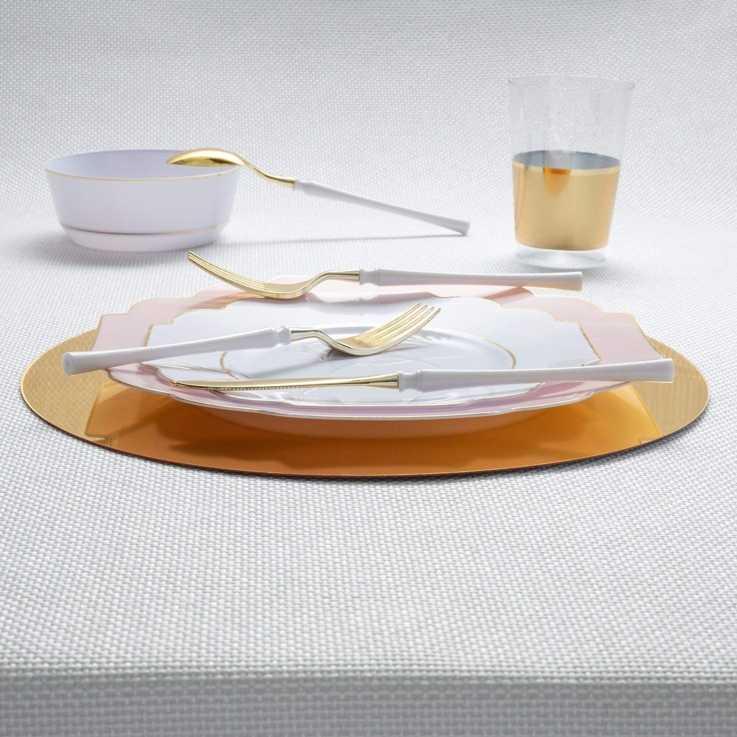 Gold and white dinnerware set with plates and cutlery for elegant event from Parte Haus party supply store in Bethesda MD