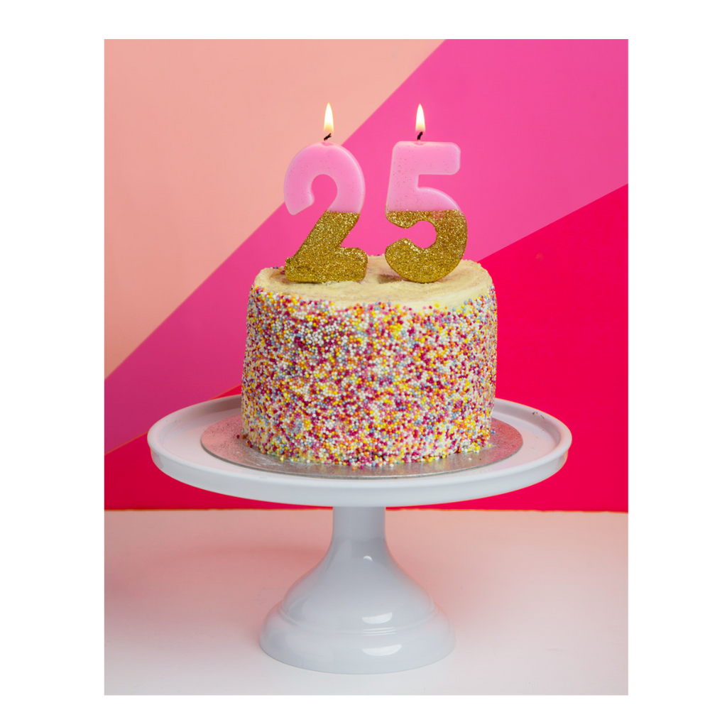 Pink and gold birthday candles on a sprinkle cake birthday decoration from Parte Haus party supply store in Bethesda Maryland