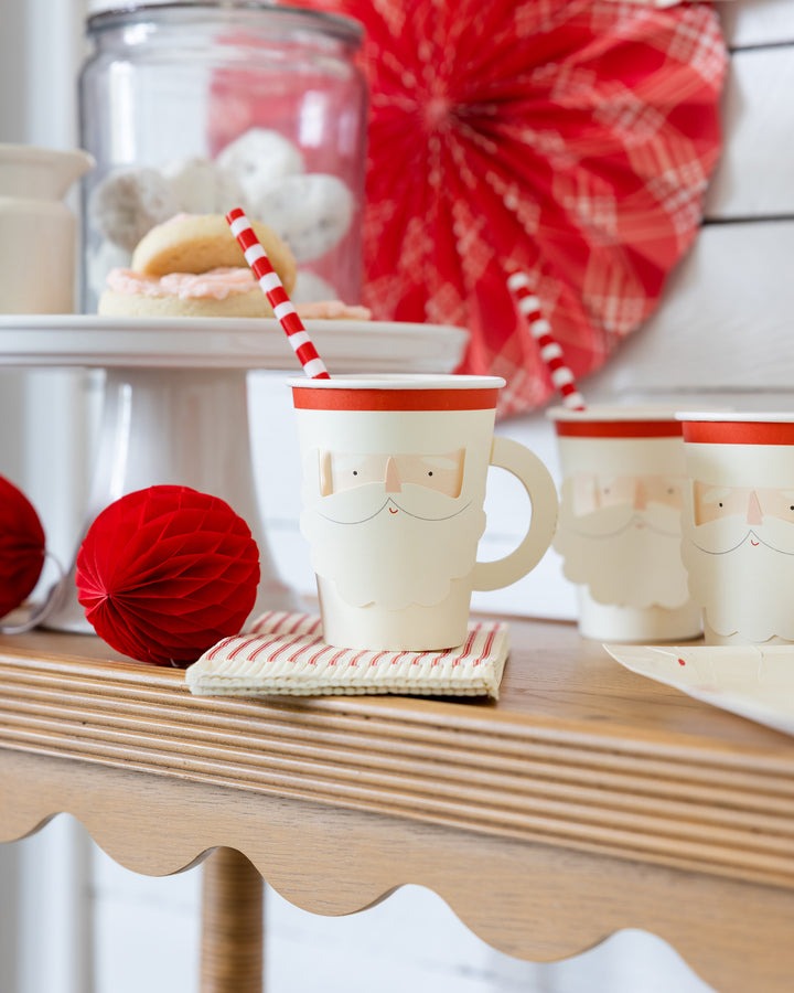 Red and white Santa paper cups with striped straws Christmas theme from Parte Haus party supply store in Bethesda MD