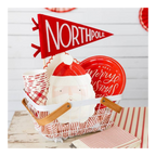 Red and white Christmas tableware set with Santa plates and North Pole flag for holiday party from Parte Haus party supply store in Bethesda Maryland