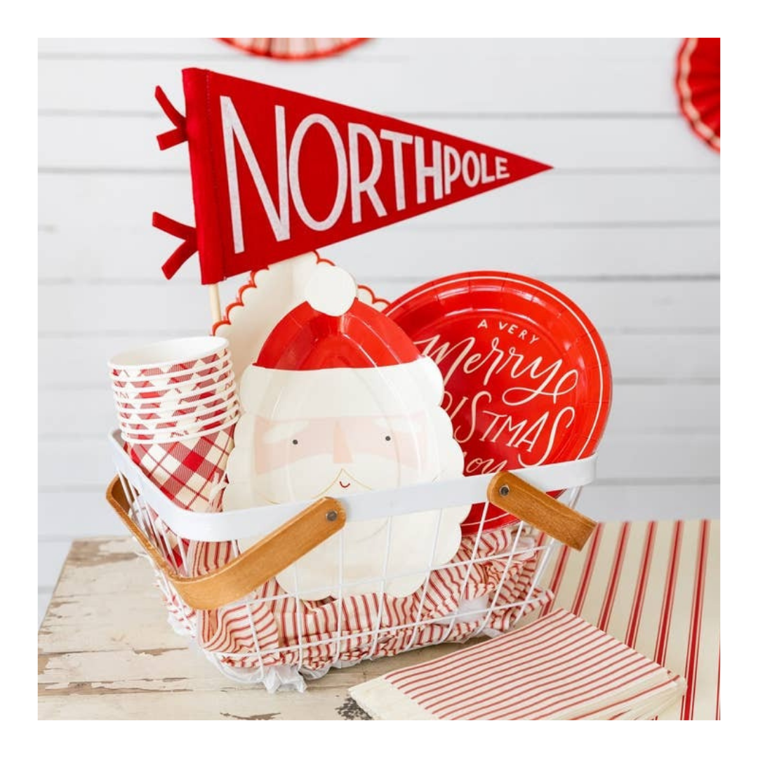 Red and white Christmas tableware set with Santa plates and North Pole flag for holiday party from Parte Haus party supply store in Bethesda Maryland