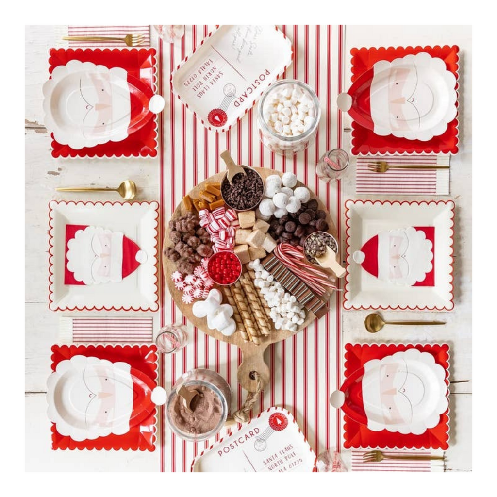 Red and white Santa Claus plates and napkins holiday table setup Christmas theme from Parte Haus party supply store in Bethesda MD