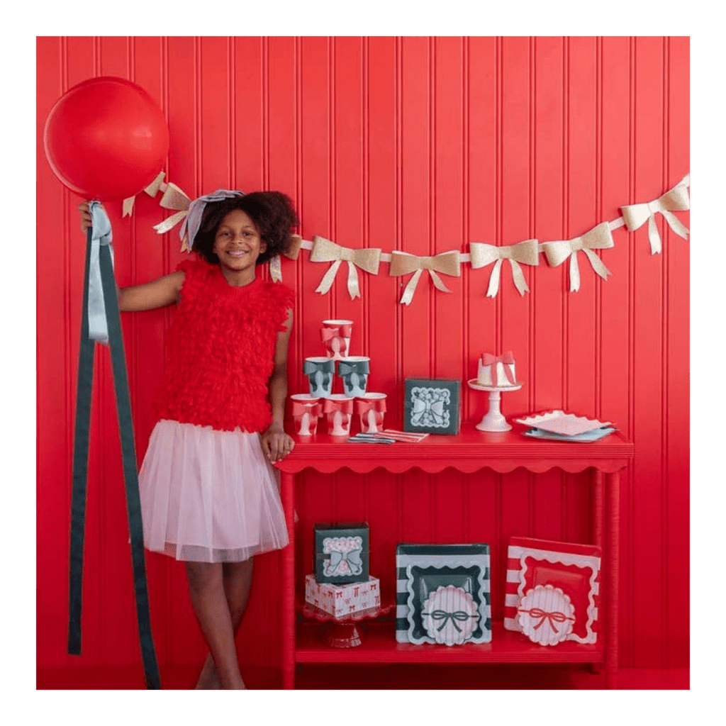 Red and white kids party setup with bows theme birthday decor from Parte Haus party supply store in Bethesda MD