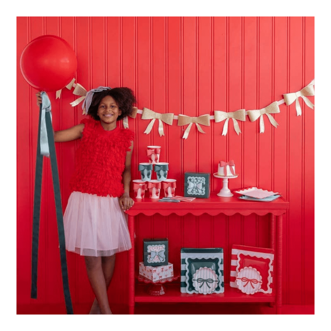 Red and white kids party setup with bows theme birthday decor from Parte Haus party supply store in Bethesda MD