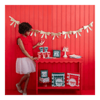 Red and white bow-themed party table setting Christmas banner decor from Parte Haus party supply store in Bethesda MD