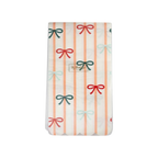 Peach striped and bow plastic table cover with pastel bow accents birthday theme from Parte Haus party supply store in Bethesda MD