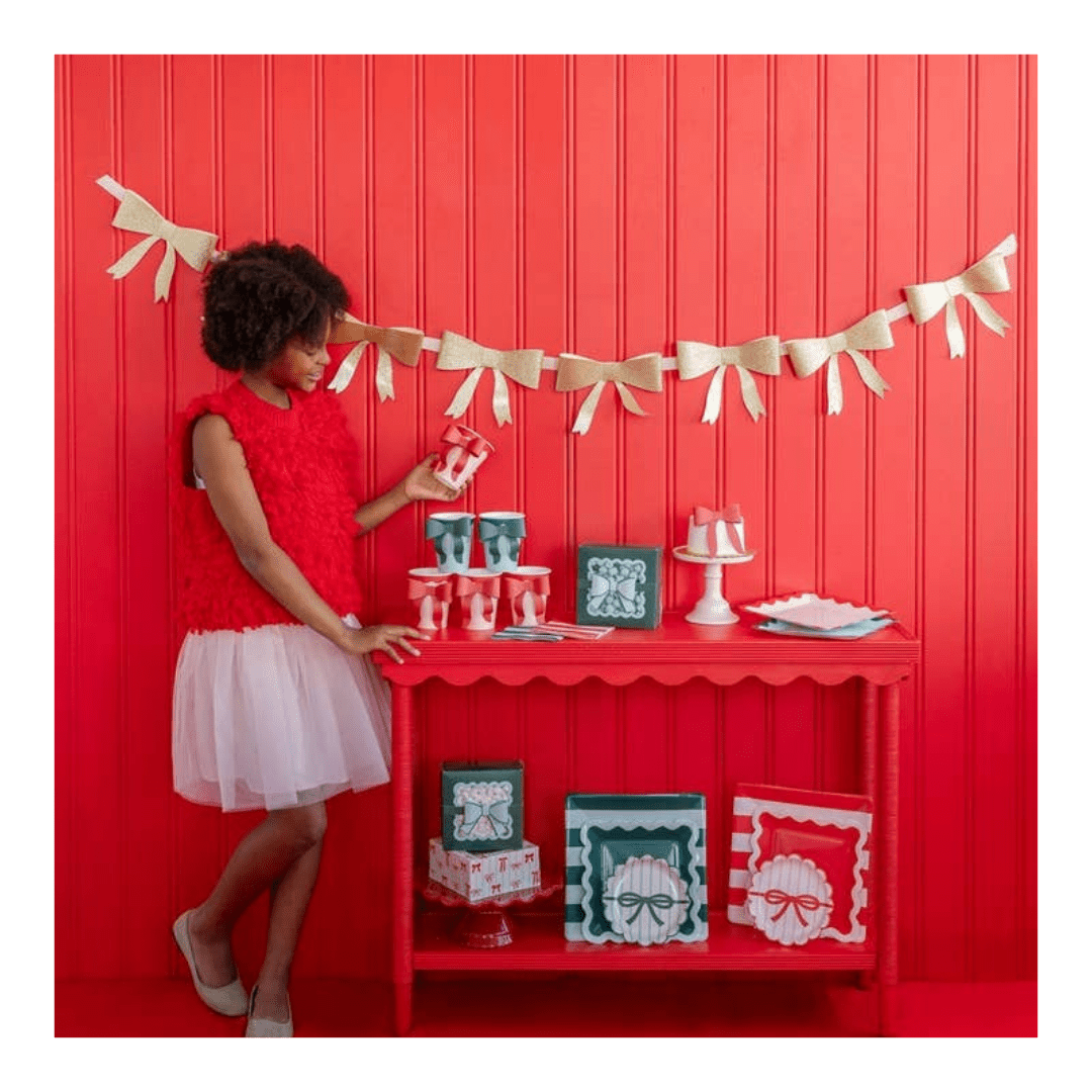 Red and white holiday table decor with bows and festive treats Christmas theme from Parte Haus party supply store in Bethesda MD