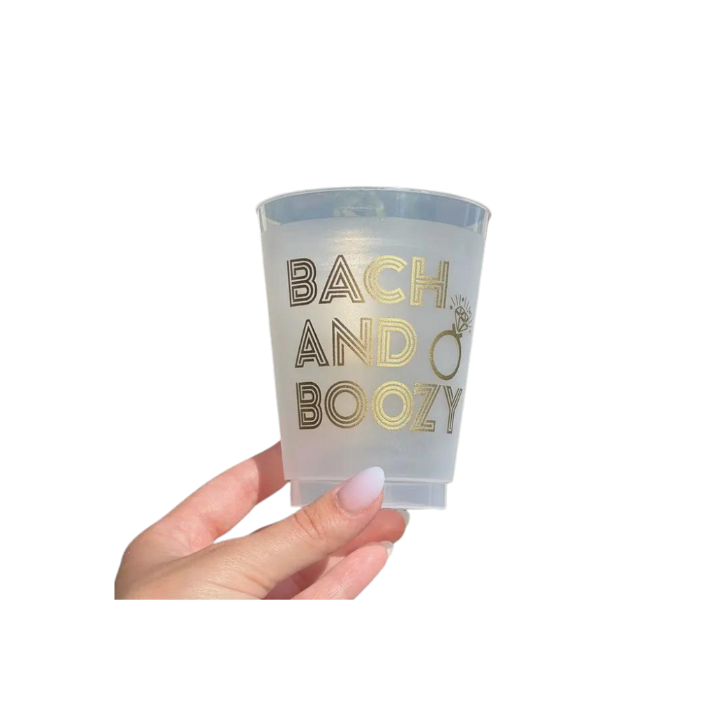 Gold frosted plastic cup with Bach and Boozy text and ring graphic for bachelorette from Parte Haus party supply store in Bethesda MD