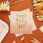 Beige and gold forty dinner napkin with metallic lettering for 40th birthday from Parte Haus party supply store in Bethesda MD
