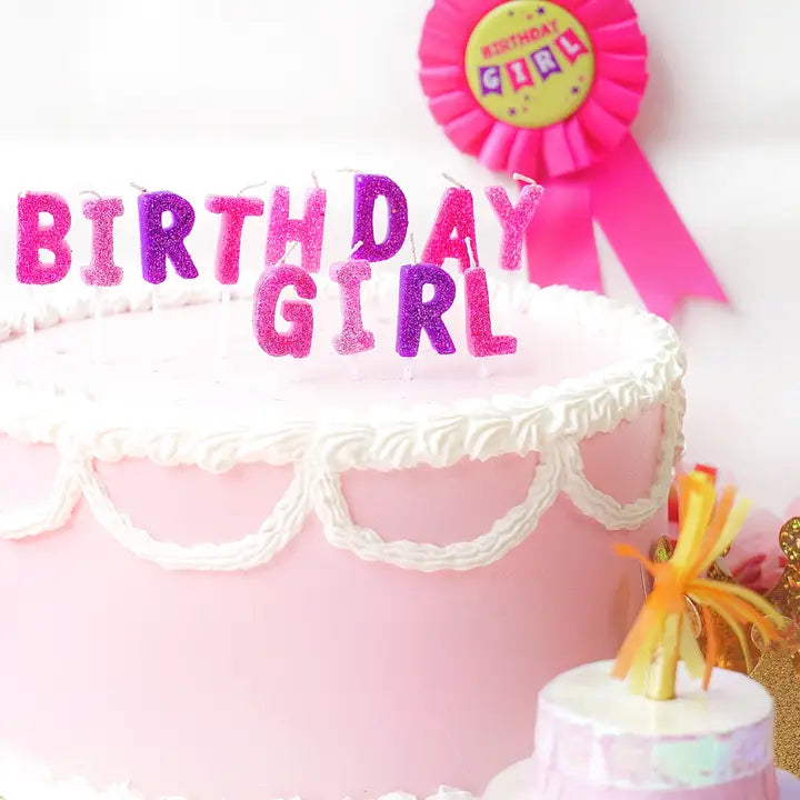 Pink and purple Birthday Girl candle set on pink frosted cake birthday theme from Parte Haus party supply store in Bethesda MD