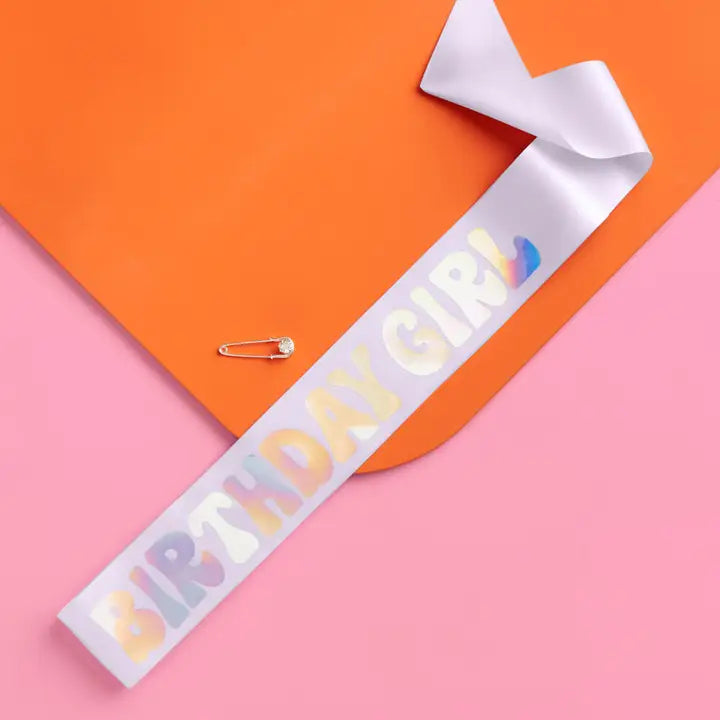 Lavender birthday girl sash with colorful letters on pink and orange from Parte Haus party supply store in Bethesda MD