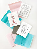 White birthday greeting cards with colorful envelopes drinks and whiskey themes from Parte Haus party supply store in Bethesda MD
