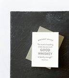 White birthday greeting card with whiskey quote on black slate birthday theme from Parte Haus party supply store in Bethesda Maryland