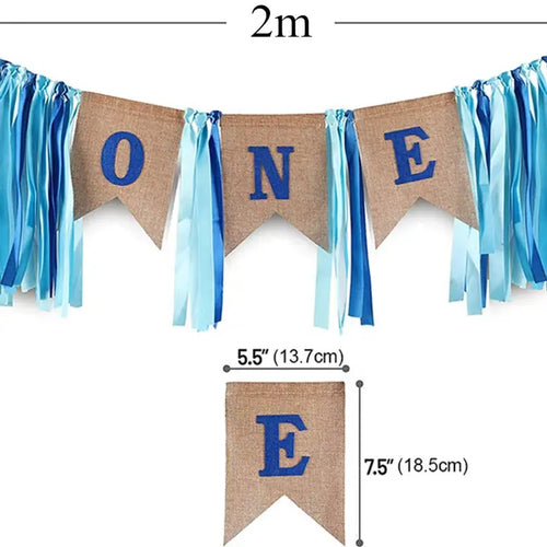 Blue birthday banner with ribbons and ONE text first birthday theme from Parte Haus party supply store in Bethesda Maryland