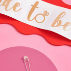 White bride to be sash with gold lettering for bachelorette party from Parte Haus party supply store in Bethesda MD