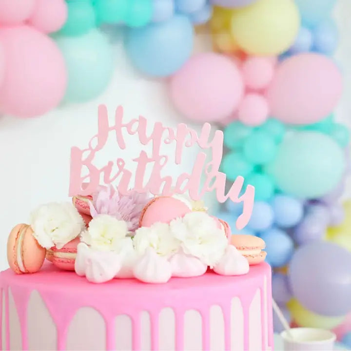 Pink happy birthday cake topper with flowers and macarons for birthday from Parte Haus party supply store in Bethesda Maryland