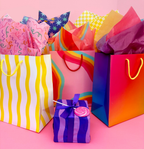 Colorful gradient gift bag with rainbow design and tissue paper birthday from Parte Haus party supply store in Bethesda Maryland