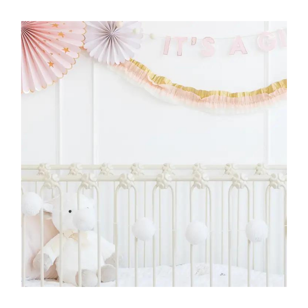 Cream basic pom pom banner with fluffy texture for baby shower from Parte Haus party supply store in Bethesda Maryland