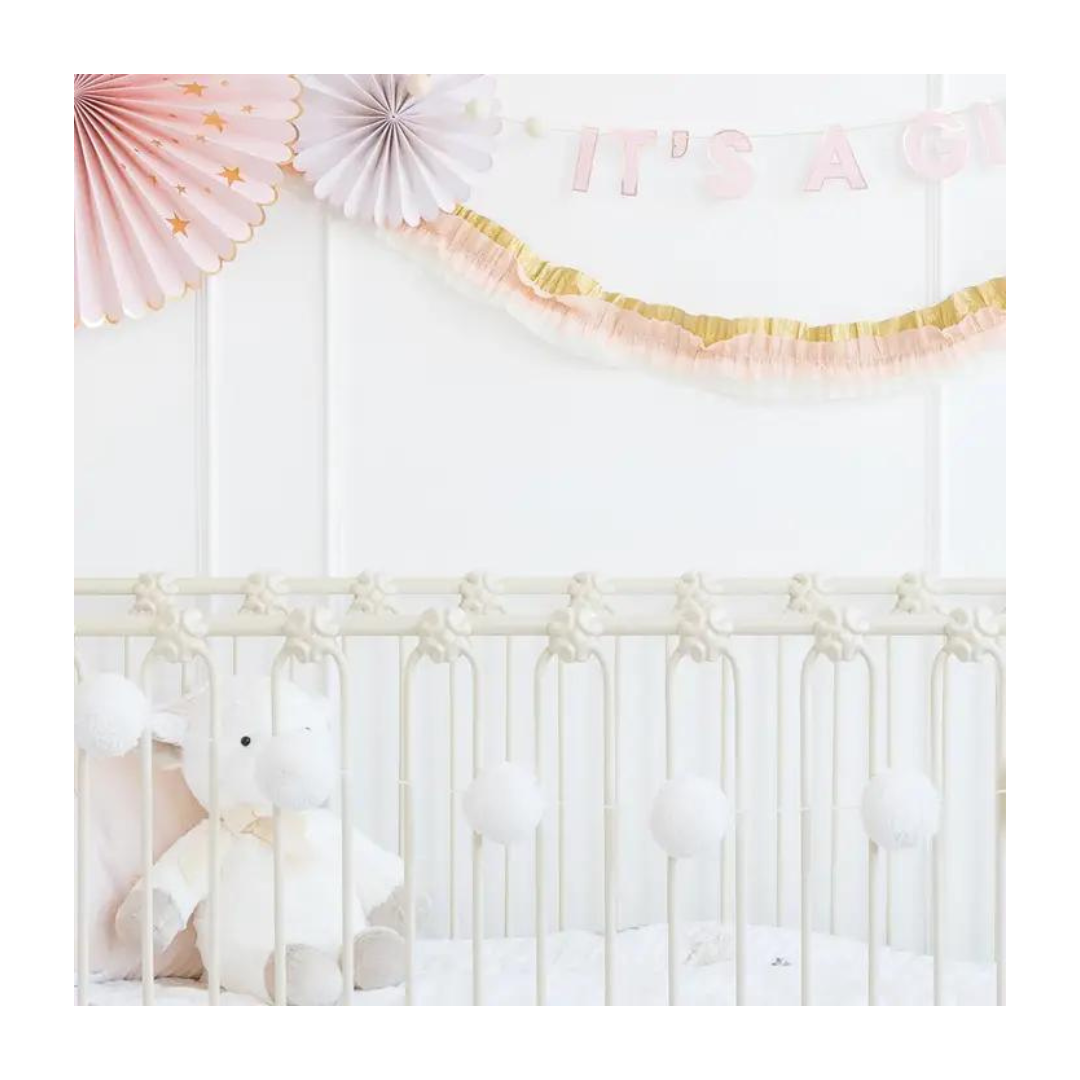 Cream basic pom pom banner with fluffy texture for baby shower from Parte Haus party supply store in Bethesda Maryland