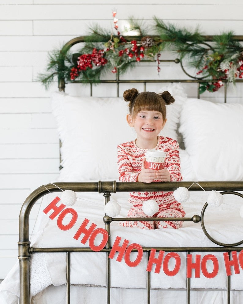 Cream basic pom pom banner with white fluffy balls for Christmas from Parte Haus party supply store in Bethesda MD
