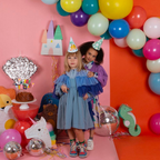 Colorful dinosaur hats with playful party theme on children for birthday from Parte Haus party supply store in Bethesda MD