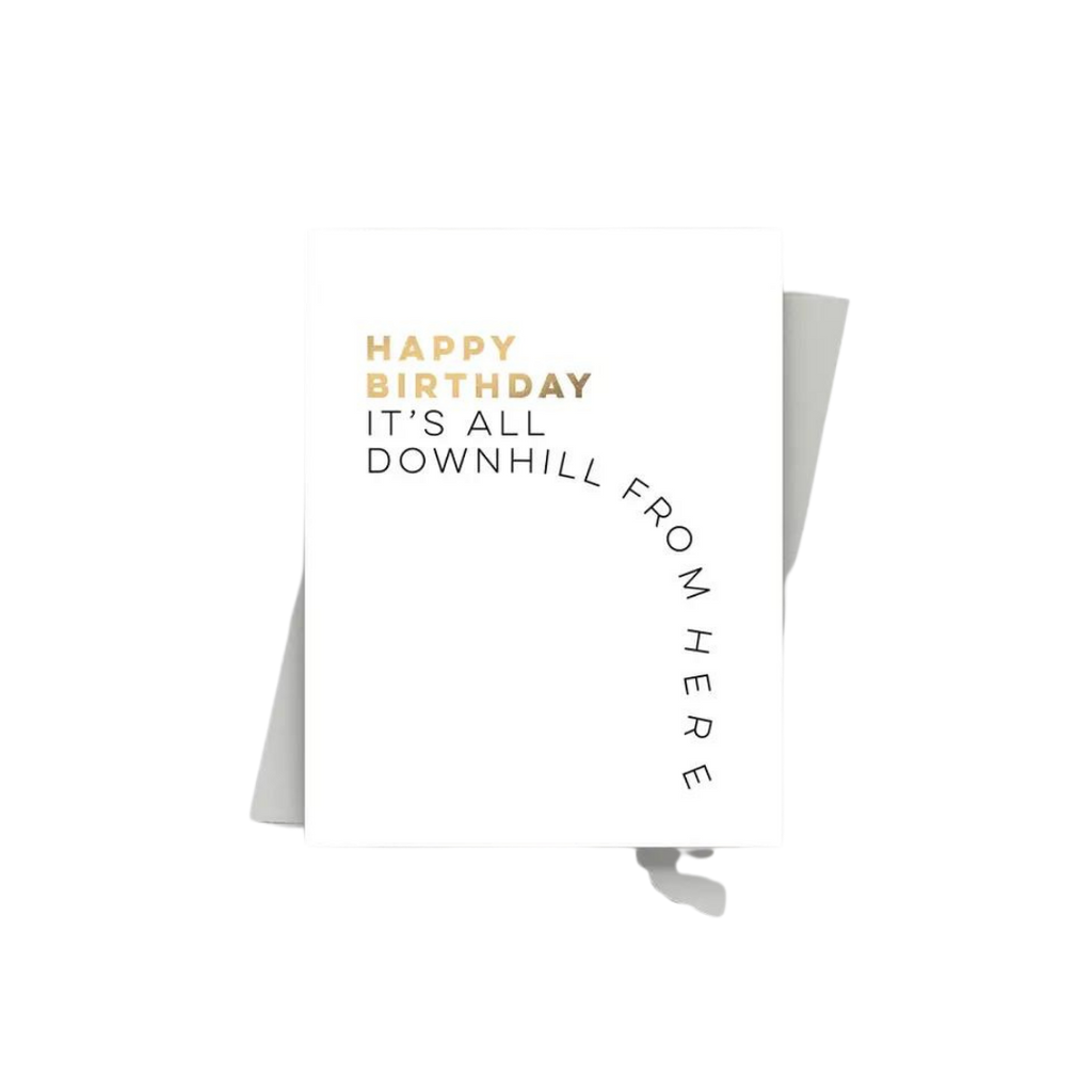 White and gold birthday card with humorous downhill text Birthday from Parte Haus party supply store in Bethesda Maryland