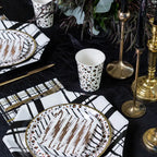 Black and gold cocktail napkins with modern stripe design table setting celebration from Parte Haus party supply store in Bethesda Maryland