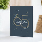 Navy blue birthday greeting card with gold sixty five star accents for 65th birthday from Parte Haus party supply store in Bethesda Maryland