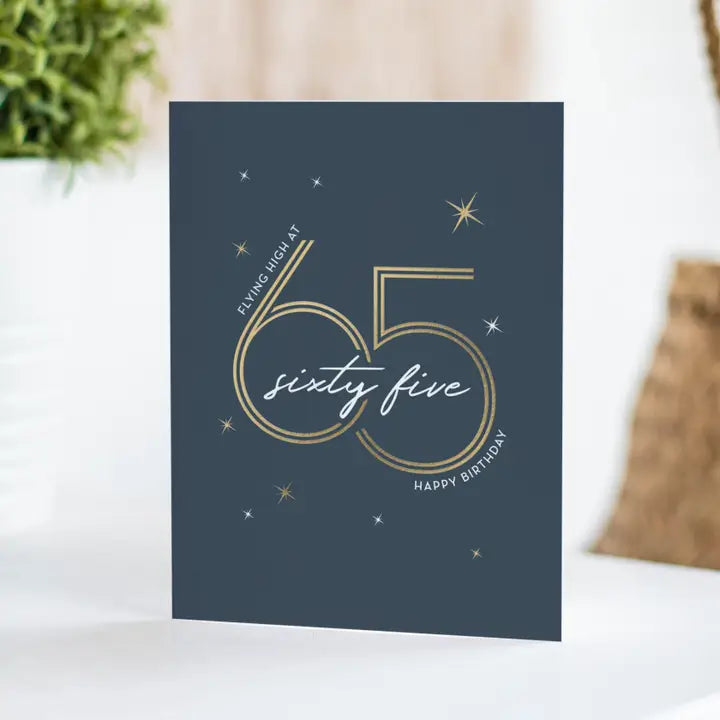Navy blue birthday greeting card with gold sixty five star accents for 65th birthday from Parte Haus party supply store in Bethesda Maryland