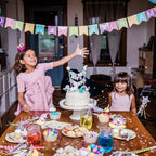 Colorful kids birthday banner and cake with unicorn toppers celebration from Parte Haus party supply store in Bethesda MD