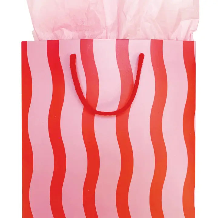 Pink and red striped gift bag with tissue paper for birthday from Parte Haus party supply store in Bethesda MD