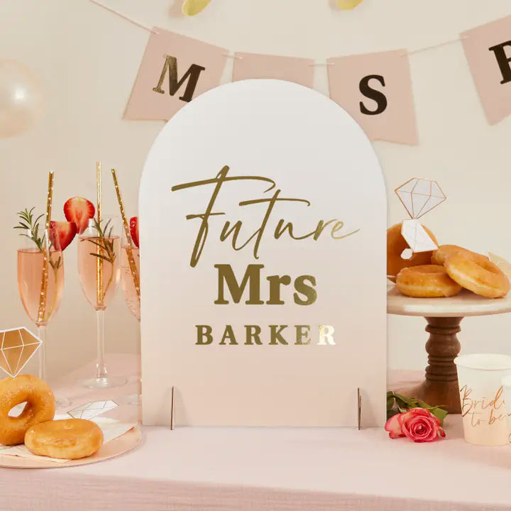 White and gold bridal shower sign with Future Mrs text with donuts and champagne from Parte Haus party supply store in Bethesda Maryland
