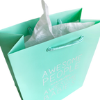 Mint green gift bag with white tissue for baby shower from Parte Haus party supply store in Bethesda Maryland