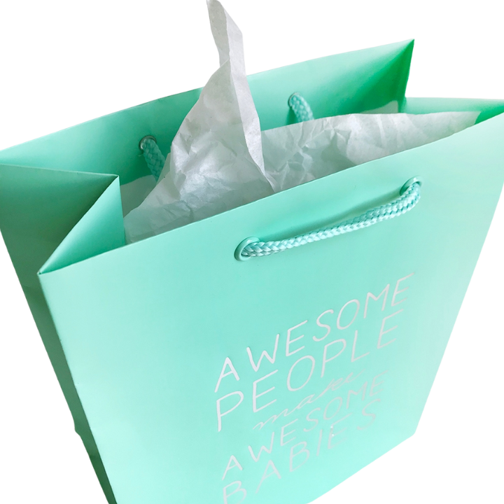Mint green gift bag with white tissue for baby shower from Parte Haus party supply store in Bethesda Maryland