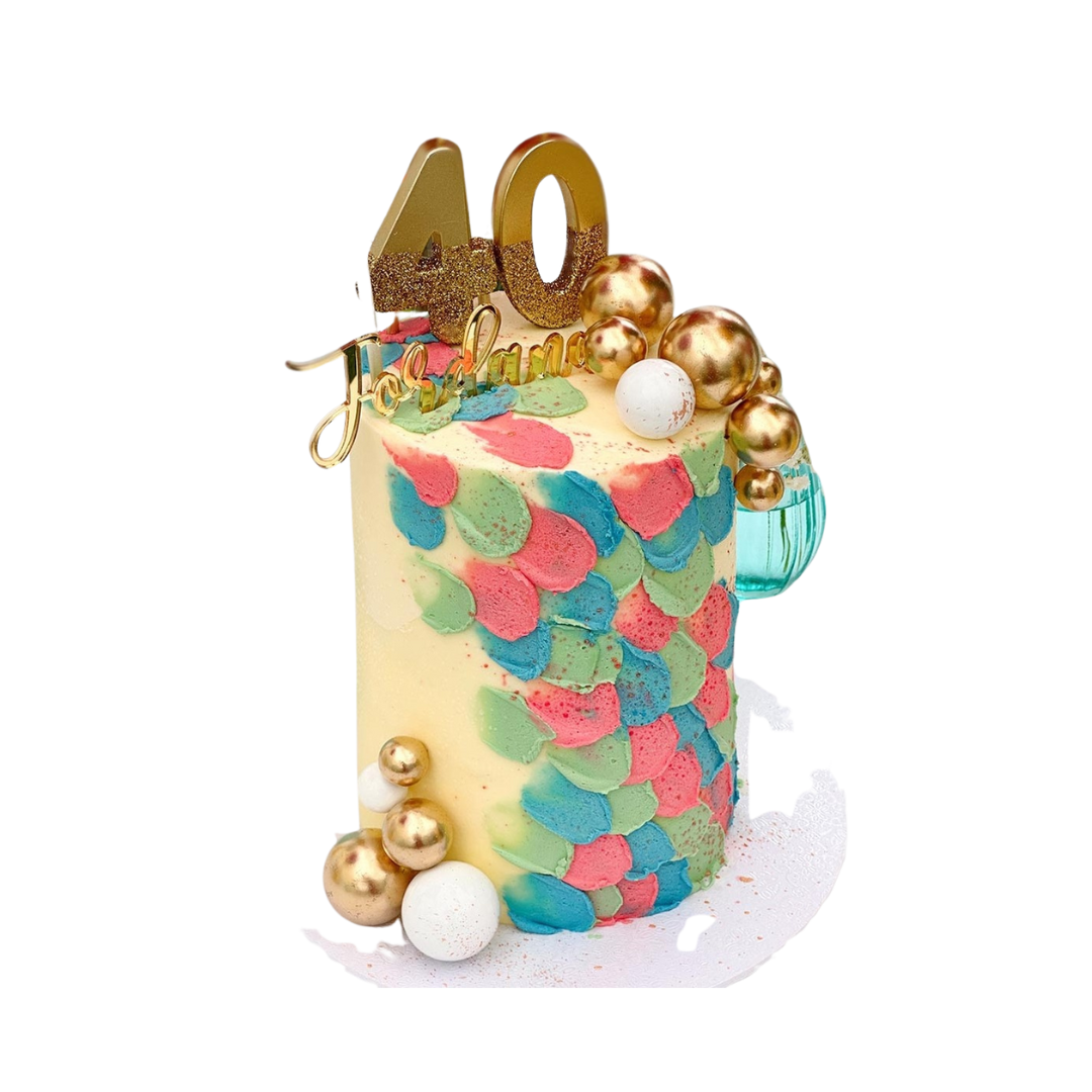 Gold glitter birthday number candles on a colorful cake birthday celebration from Parte Haus party supply store in Bethesda Maryland