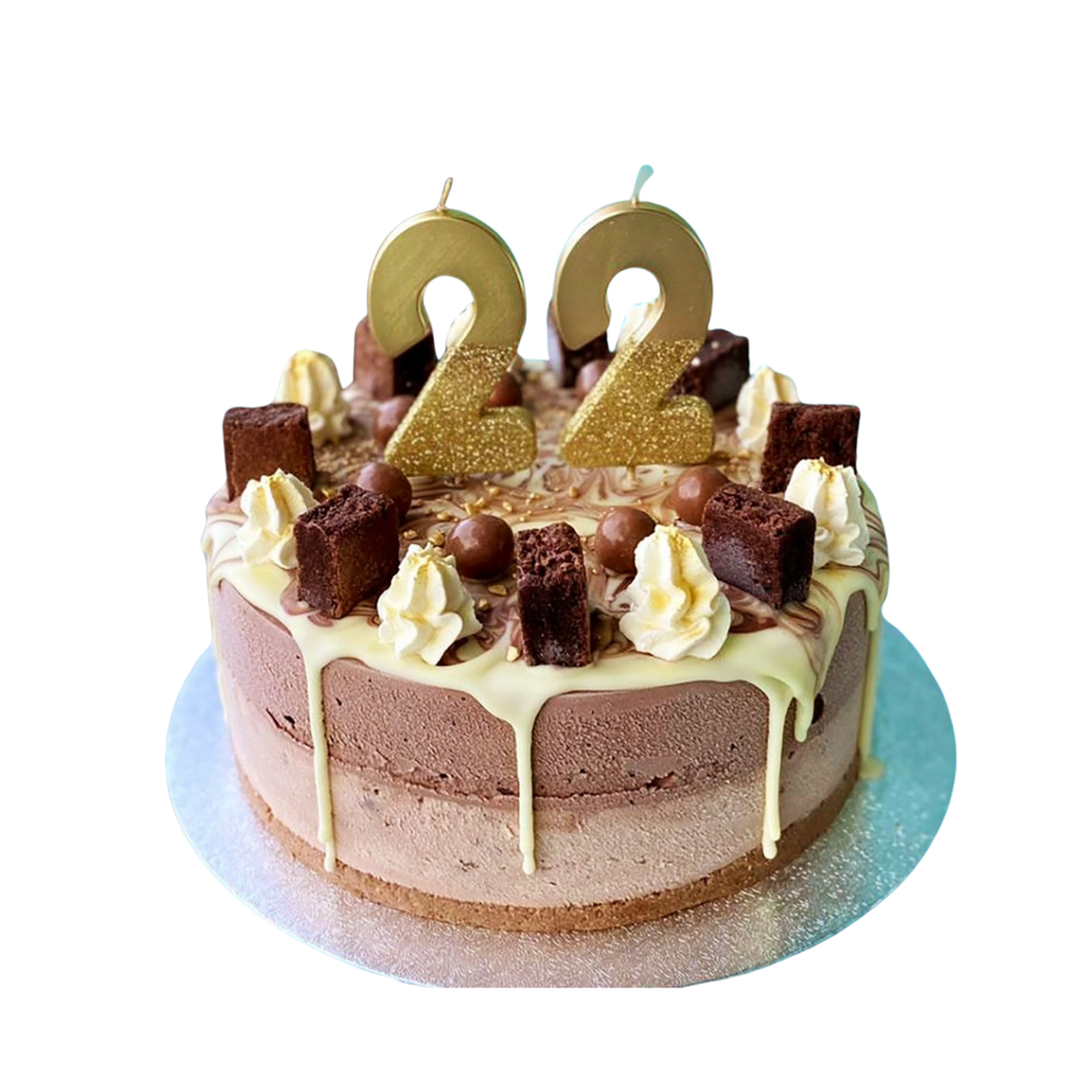 Gold glitter birthday number candles set on chocolate cake for birthday theme from Parte Haus party supply store in Bethesda Maryland