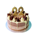 Gold glitter birthday number candles set on chocolate cake for birthday theme from Parte Haus party supply store in Bethesda Maryland