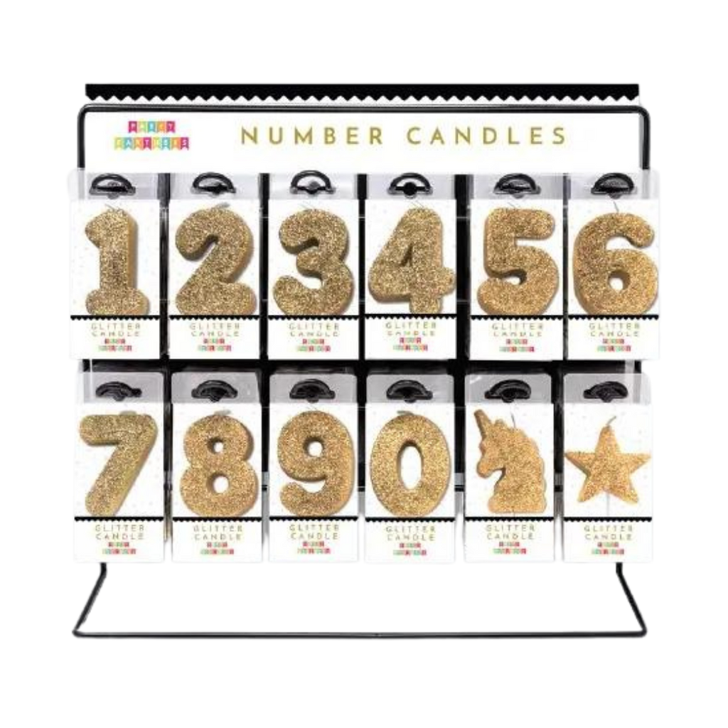 Gold glitter number candle set with unicorn and star birthday display from Parte Haus party supply store in Bethesda Maryland
