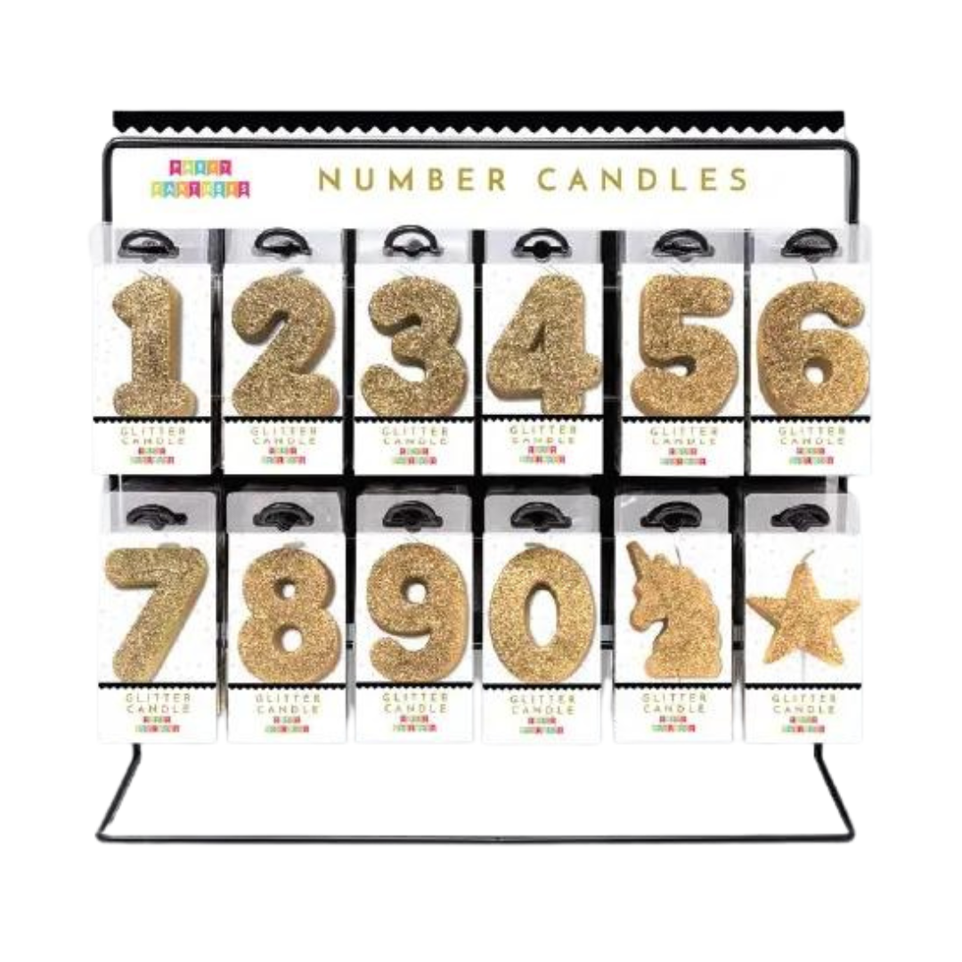 Gold glitter number candle set with unicorn and star birthday display from Parte Haus party supply store in Bethesda Maryland