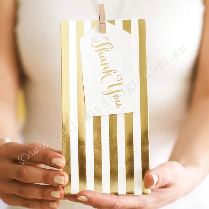 Gold striped treat bag with thank you tag for celebrations from Parte Haus party supply store in Bethesda MD