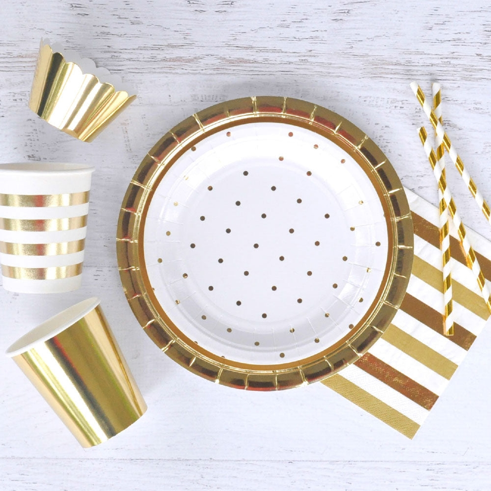 Gold foil cups and plates with matching straws and napkins for celebration from Parte Haus party supply store in Bethesda MD