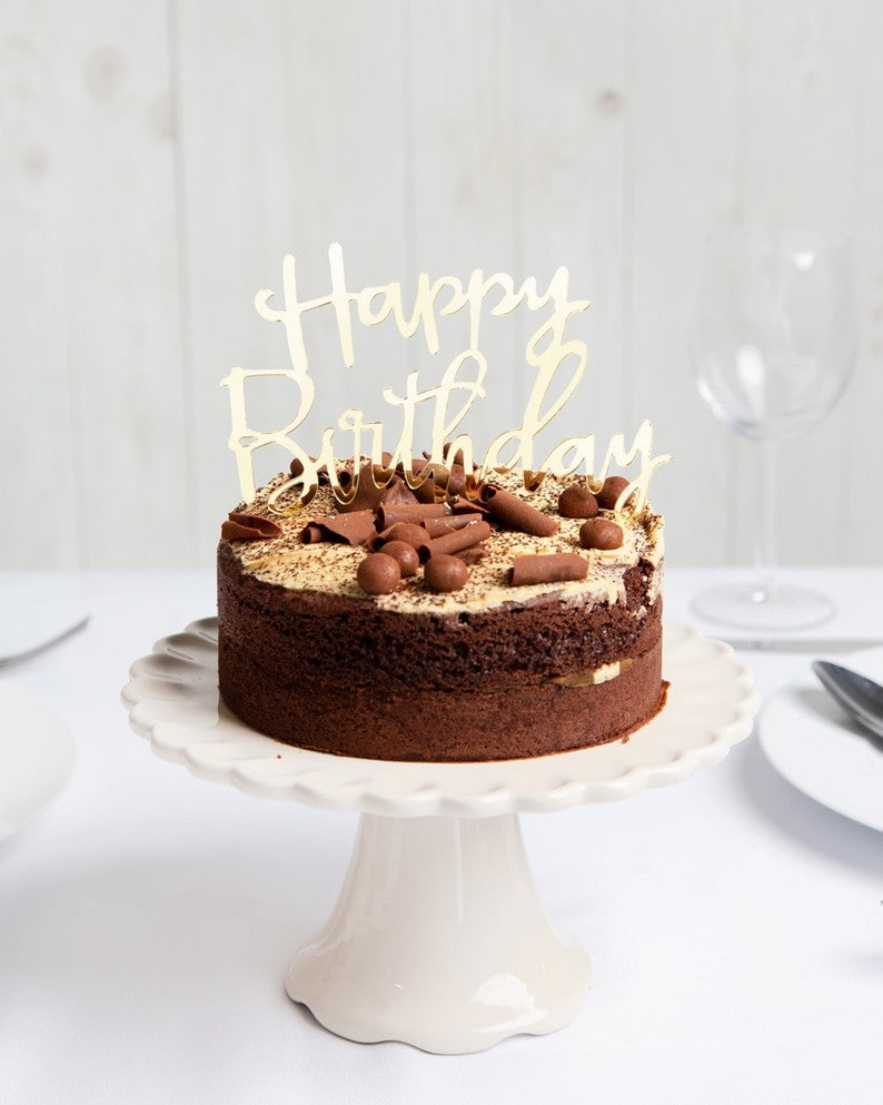 Gold Happy Birthday acrylic cake topper on chocolate cake birthday celebration from Parte Haus party supply store in Bethesda Maryland