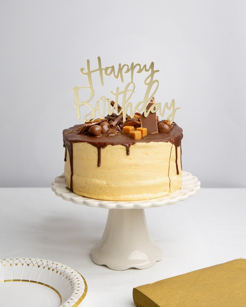 Gold Happy Birthday acrylic cake topper on chocolate cake birthday theme from Parte Haus party supply store in Bethesda MD