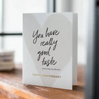 White anniversary greeting card with gold text heart backdrop for anniversary from Parte Haus party supply store in Bethesda Maryland